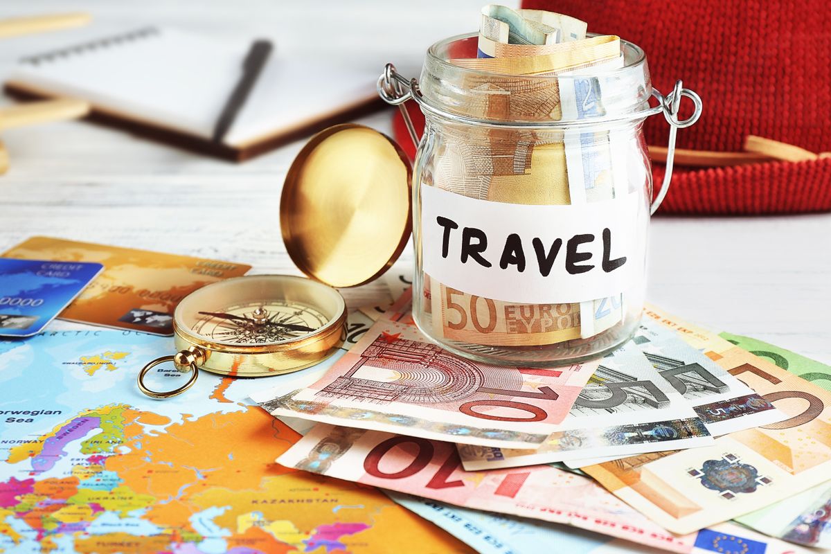 Travel,Money,Savings,In,A,Glass,Jar,With,Compass,,Map