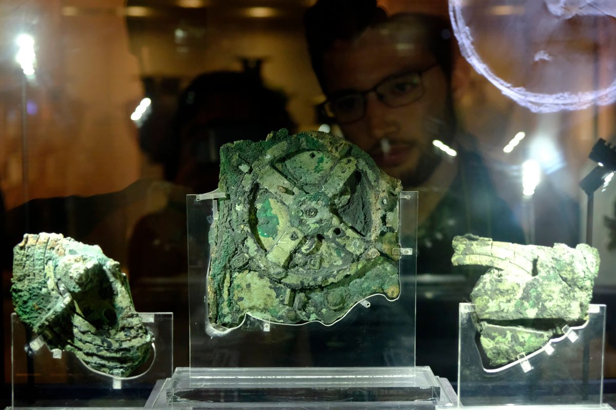 Visitors,Look,At,A,Fragment,Of,The,2,100-year-old,Antikythera,Mechanism,
