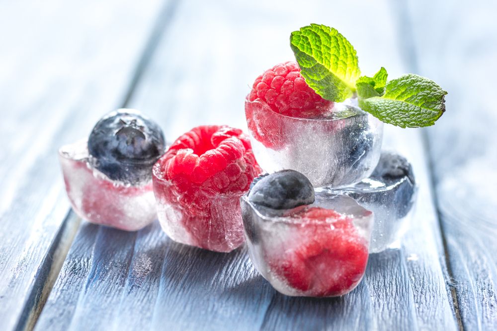 Fresh,Berries,With,Mint,In,Ice,Cubes,On,Wooden,Background
