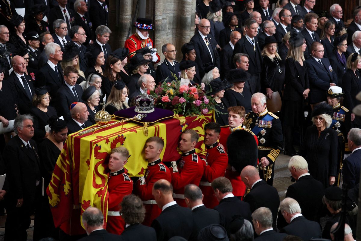 Britain's Queen Elizabeth's coffin is carried out Westminster Abbey, as Britain's King Charles and Queen Camilla follow, on the day of the state funeral and burial of Britain's Queen Elizabeth in London, Britain, on September 19, 2022. (Photo by PHIL NOBLE / POOL / AFP)