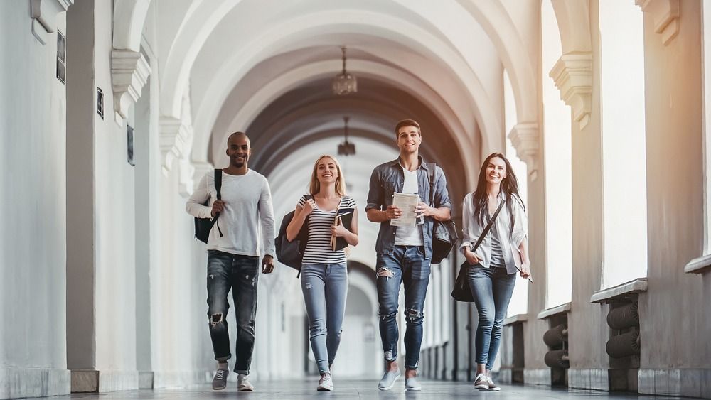 Multiracial,Students,Are,Walking,In,University,Hall,During,Break.