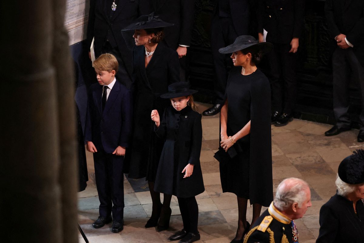 Britain's Catherine (2L), Princess of Wales, Meghan (2R), Duchess of Sussex, Prince George (L), Princess Charlotte (C), Britain's King Charles III (R) and Britain's Camilla, Queen Consort attend the state funeral and burial of Britain's Queen Elizabeth, at Westminster Abbey in London, Britain, September 19, 2022. (Photo by PHIL NOBLE / POOL / AFP)