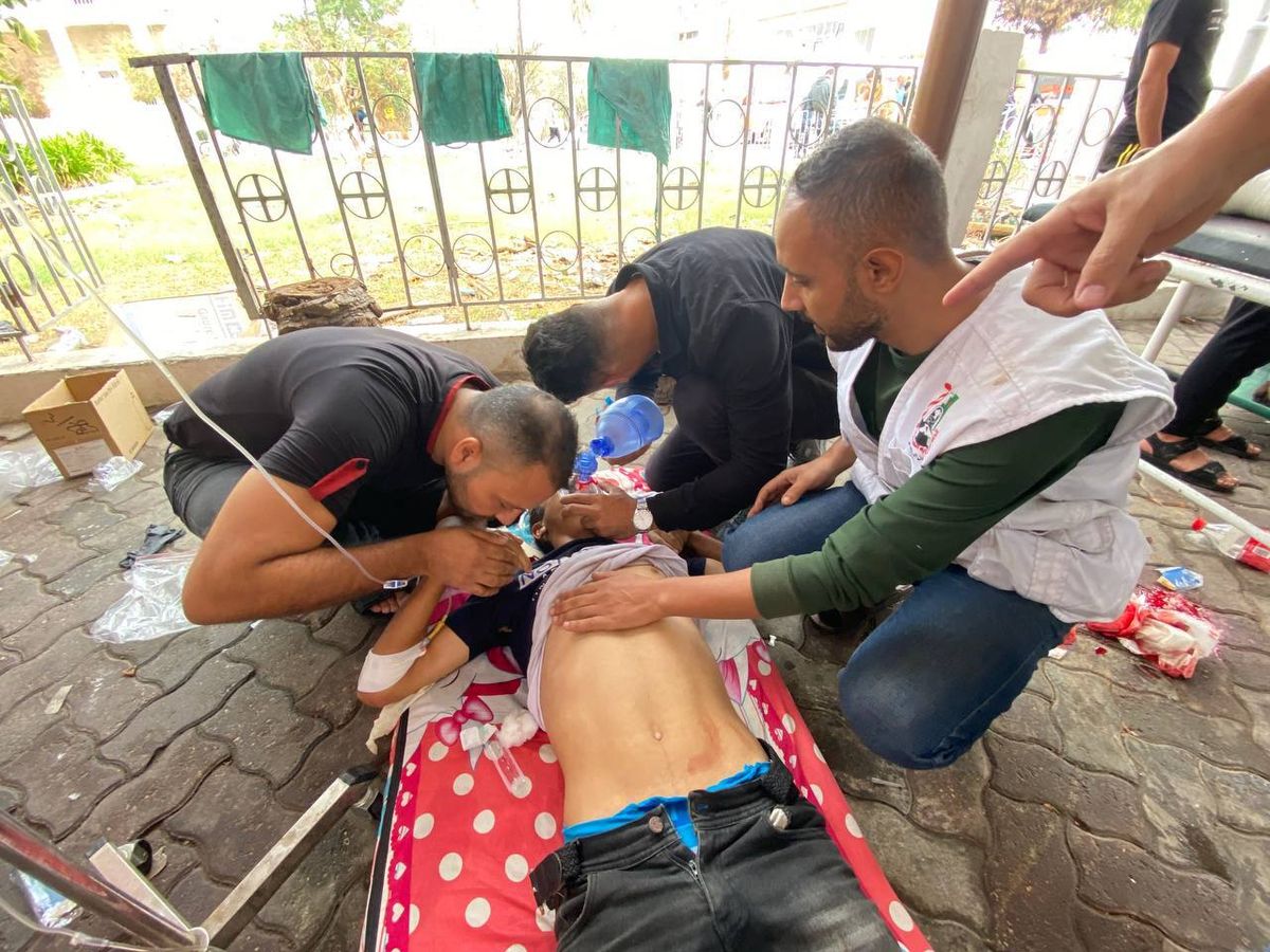 Palestinians receive medical care outside as part of hospital damaged in Gaza