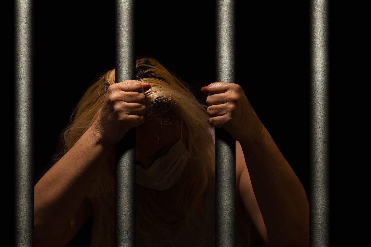 Blonde,Woman,Behind,The,Bars,,In,Dark,,Crying,And,Hiding