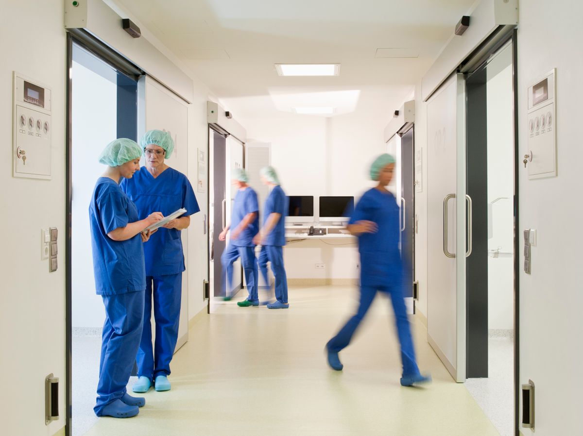 Doctors,And,Nurses,In,Scrubs,In,Hospital,,Blurred,Motion