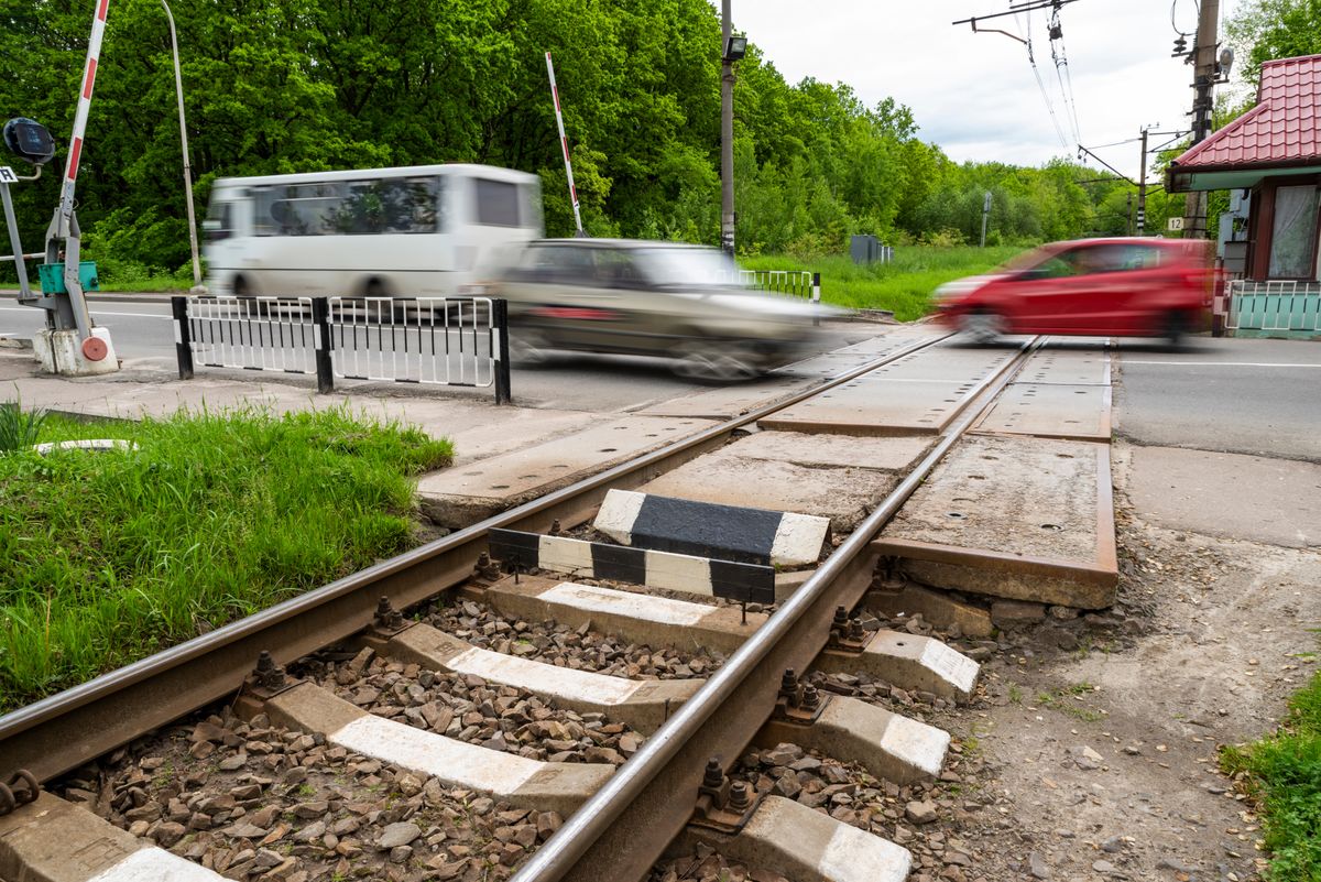 Railway,Crossing,With,Smeared,Cars,Passing,Through,It,,Selective,Sharpness