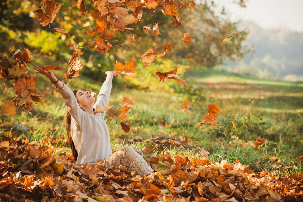 Autumn,Leaves,Falling,On,Happy,Young,Woman,In,Forest.,The