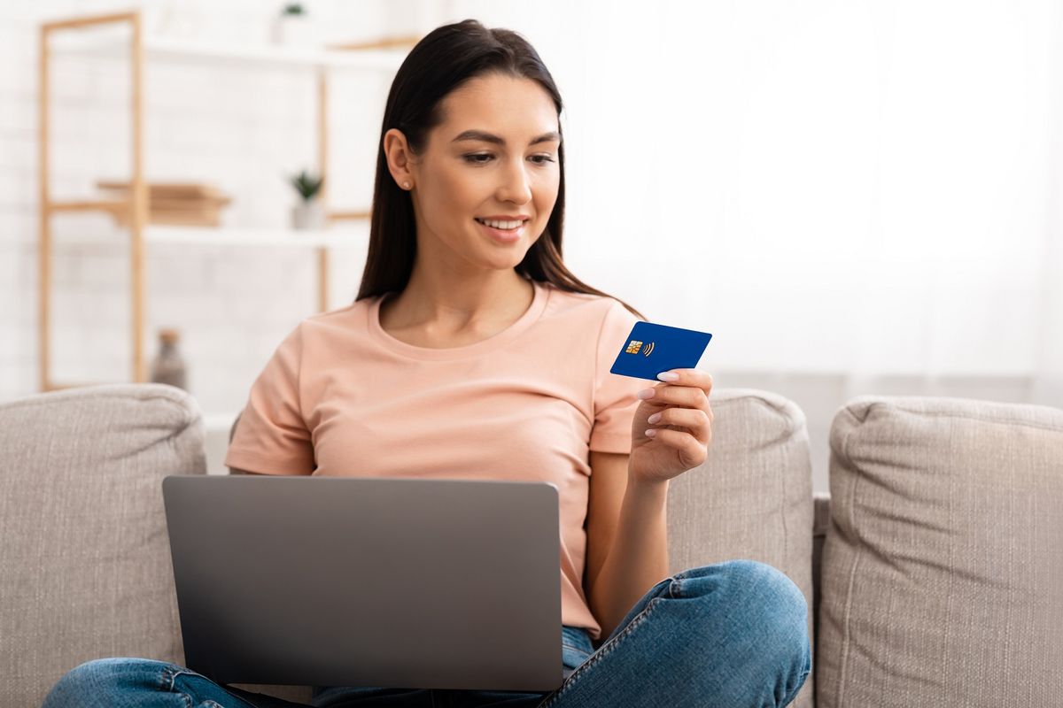 Young woman making purchases sitting on the couch