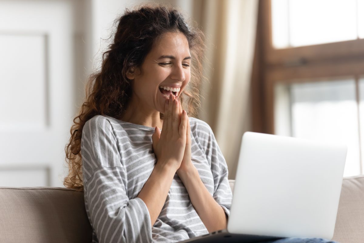 Excited,Woman,Looking,At,Laptop,Screen,,Rejoicing,Good,News,,Happy