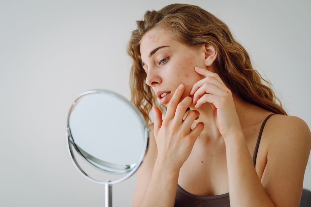 A,Beautiful,Woman,Looking,In,The,Mirror,,Touching,Her,Face