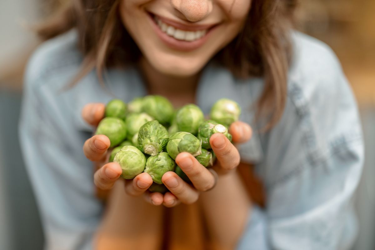 Portrait,Of,Pretty,Woman,In,Apron,With,Fresh,Brussels,Sprouts