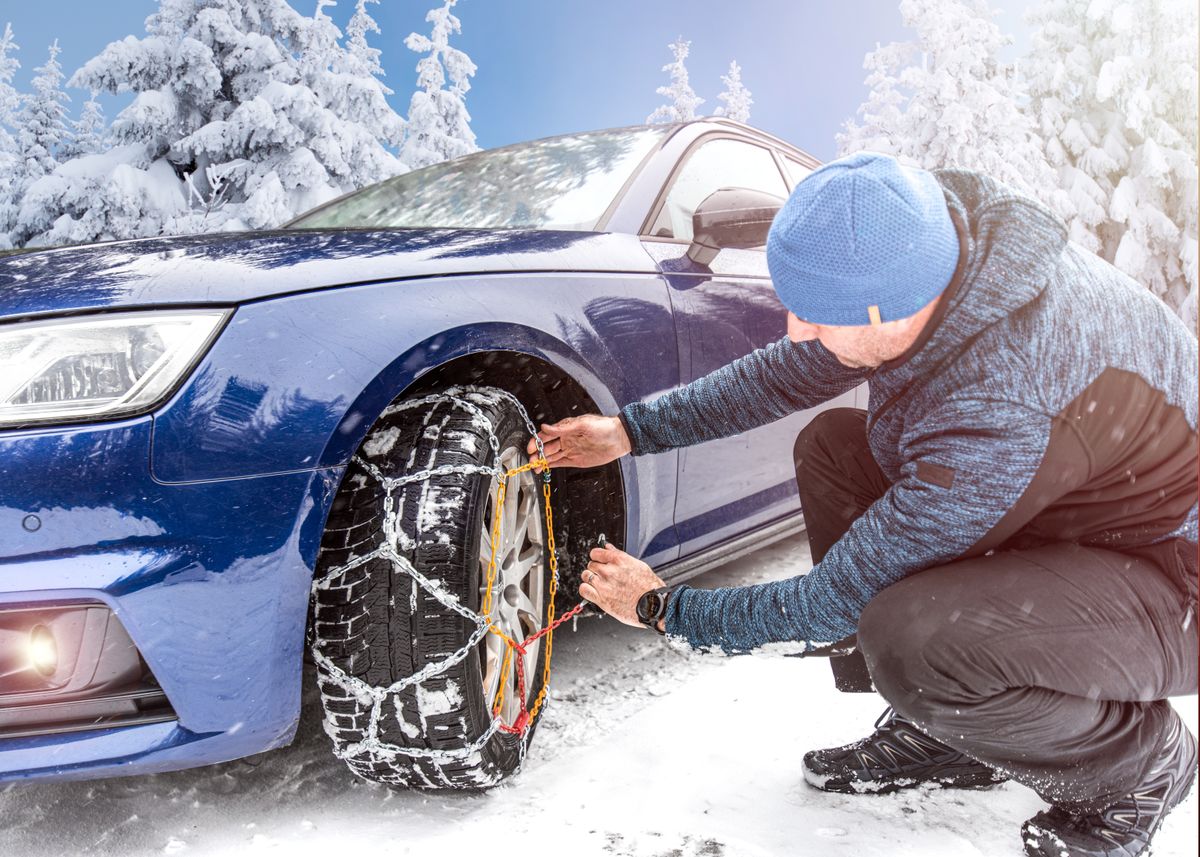 Putting,Winter,Chains,On,Car.,Man's,Hands,Putting,On,Snow