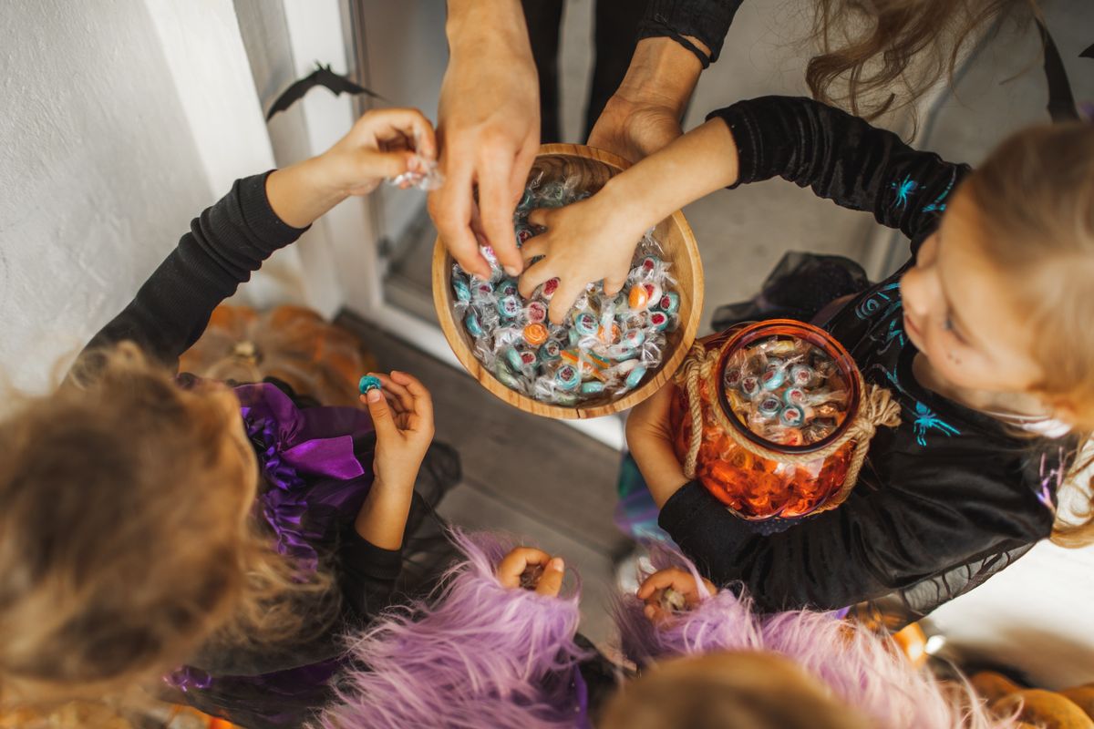 Trick or Treat tradition on Halloween. Kids asking for sweets and candies.