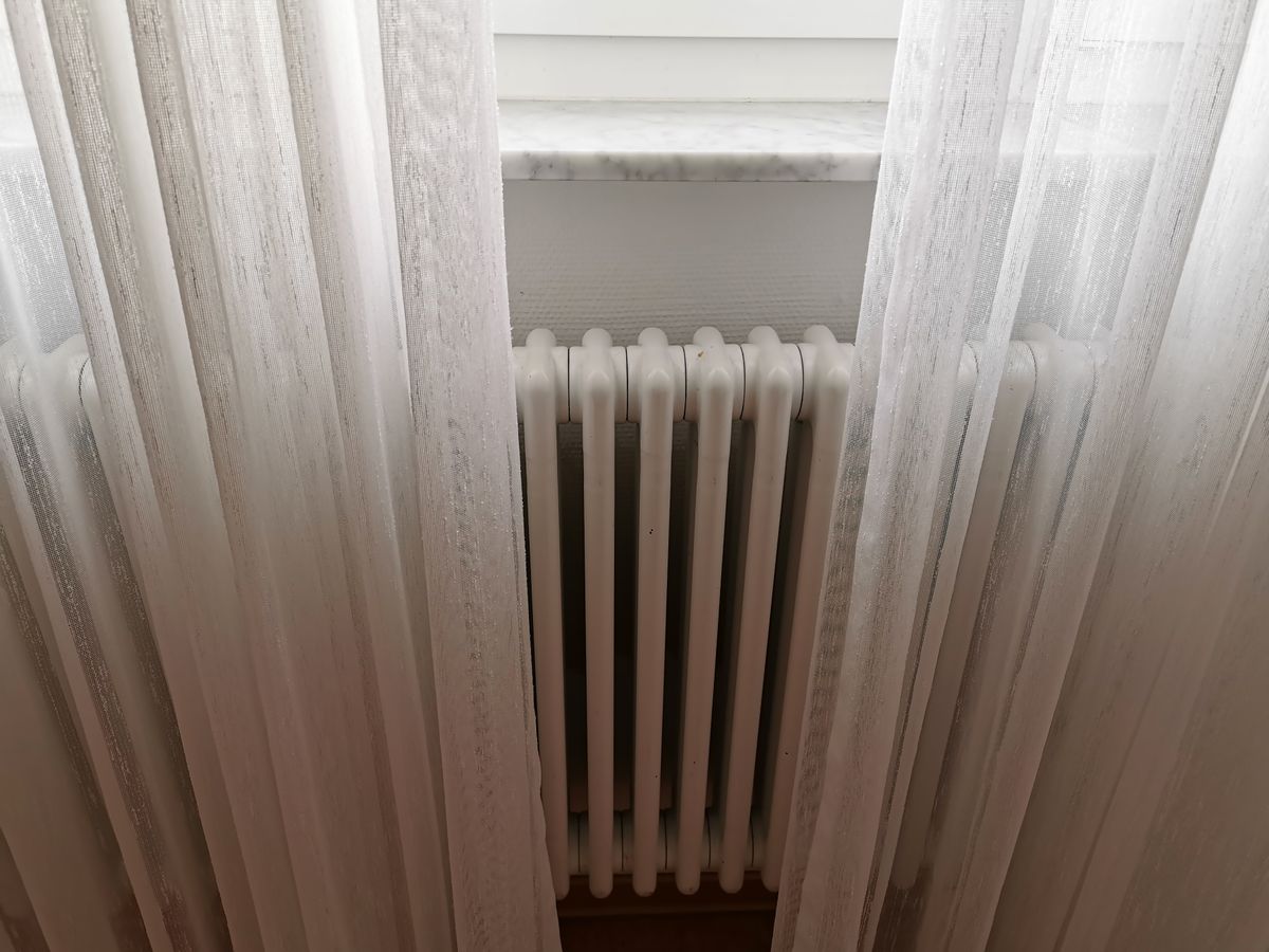 A,Closeup,Of,The,Central,Heating,Radiator,Covered,With,Light