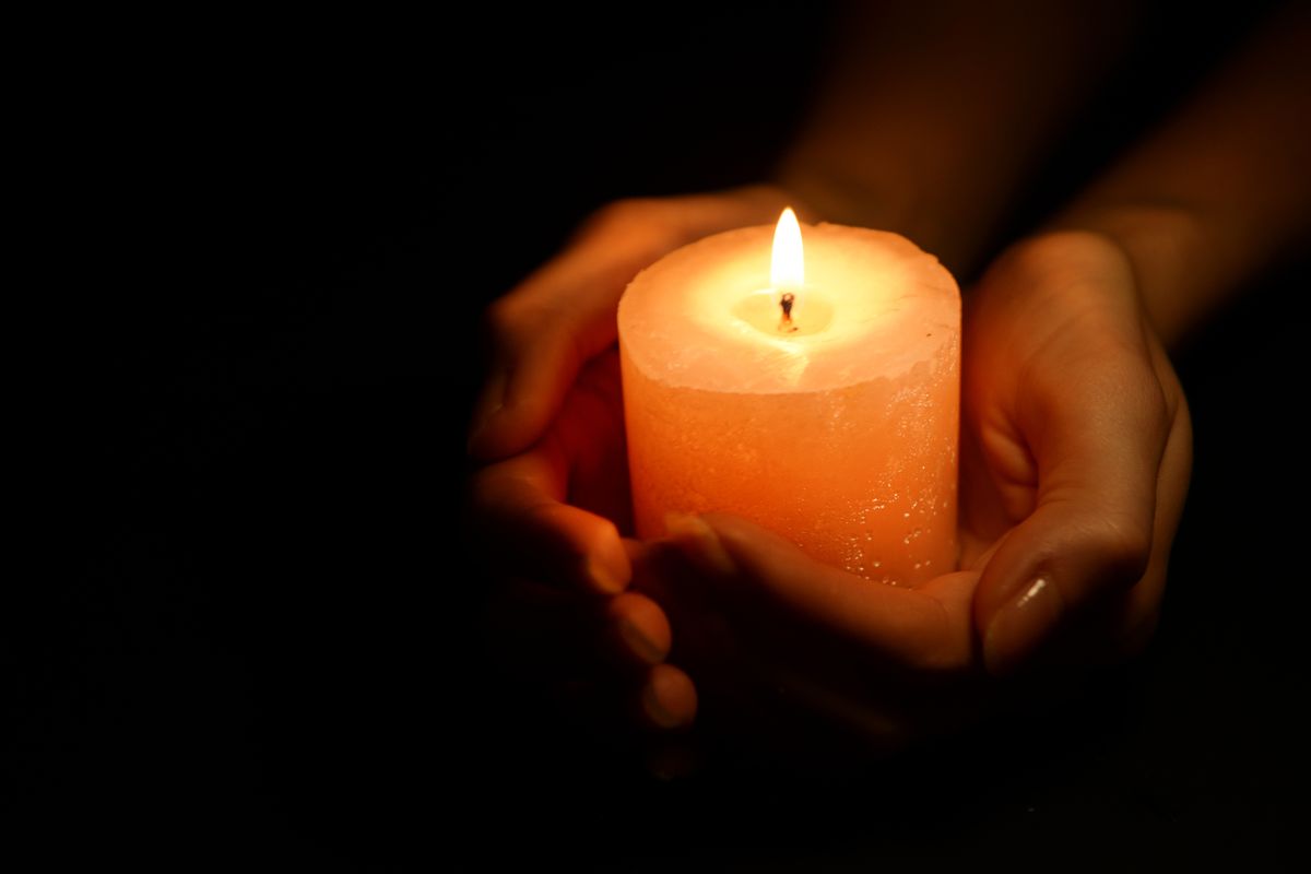 Candle,In,Female,Hands,On,Black,Background