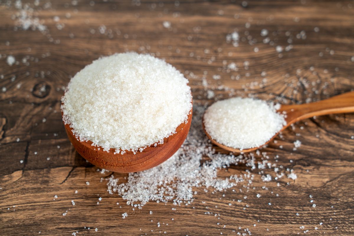 Granulated,Sugar,Filled,In,Wooden,Bowl,And,Spoon,On,Wooden