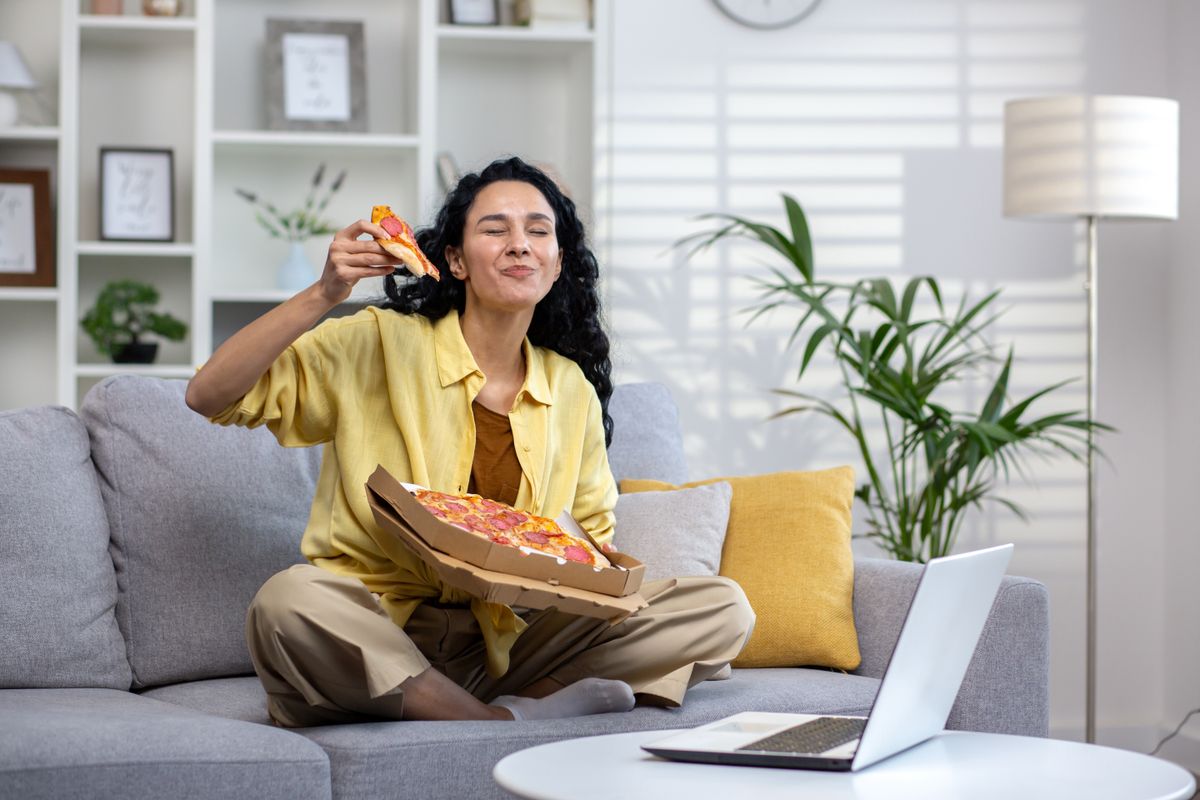 Joyful,And,Happy,Woman,Eating,Pizza,Alone,At,Home,,Hispanic