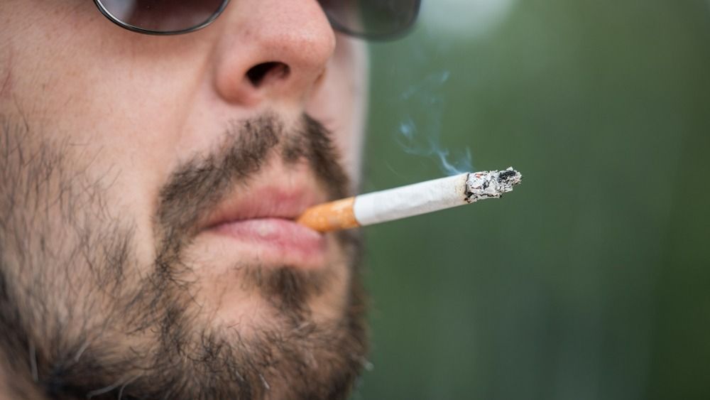 Close-up,Shot,Of,Bearded,Man,In,Sunglasses,Smoking,Cigarette.