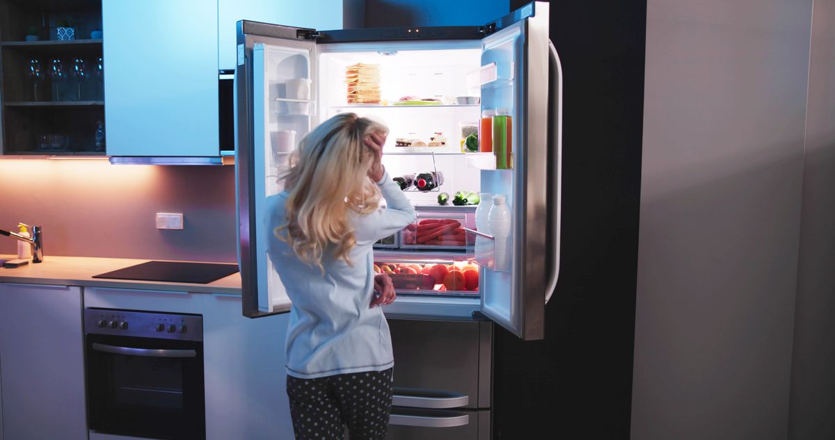 Hungry,Woman,At,Night,With,Open,Fridge