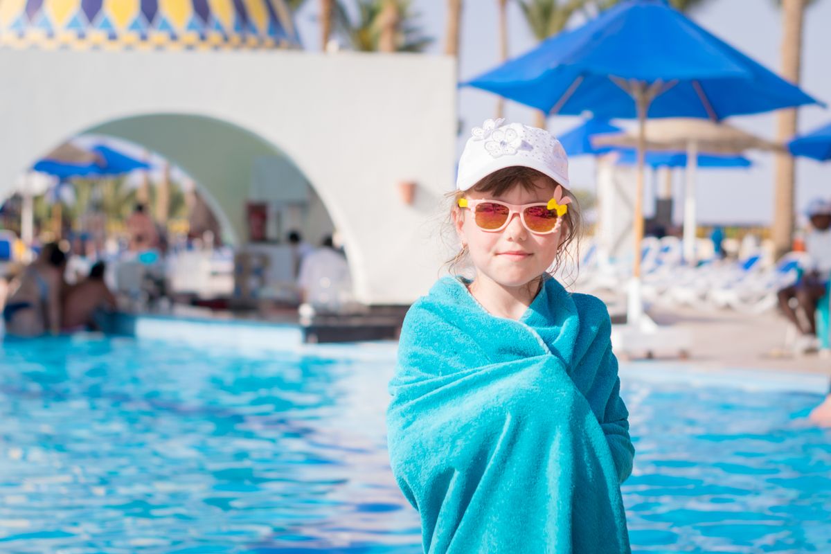A,Little,Girl,In,Sun,Glasses,Stands,Near,A,Swimming